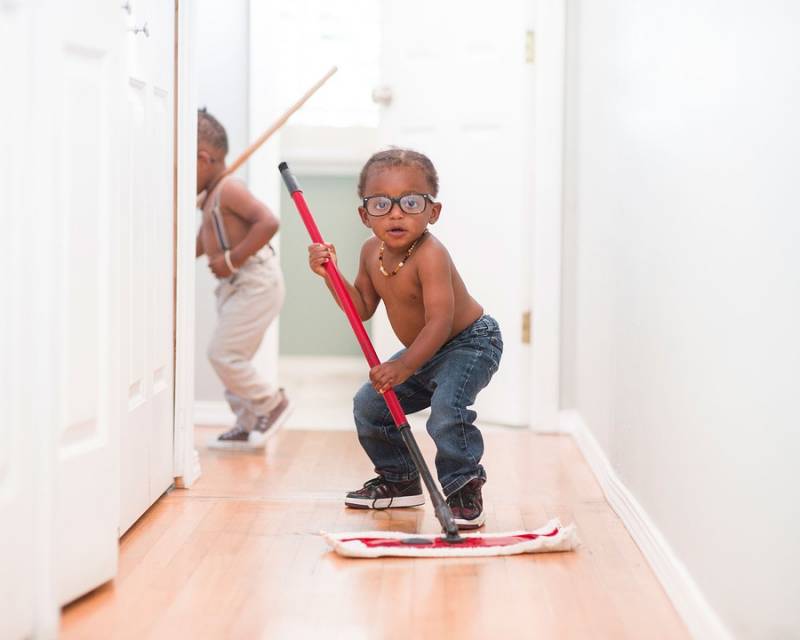 Little kids cleaning a floor