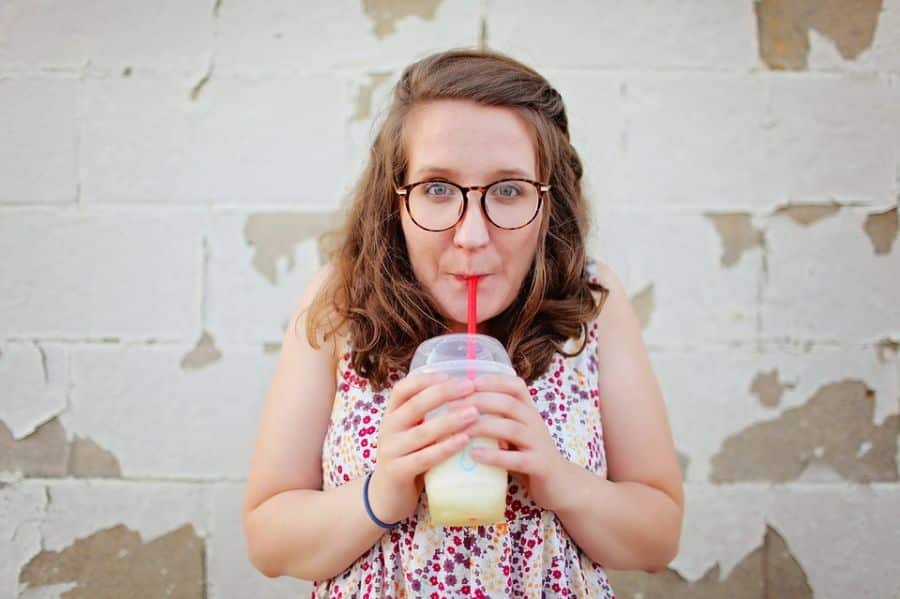 Woman drinking through a straw