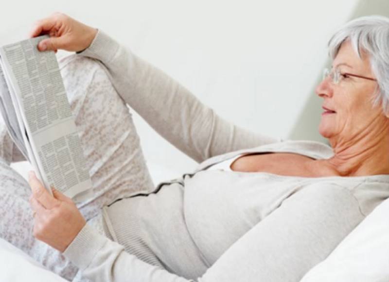 Senior woman reading a newspaper