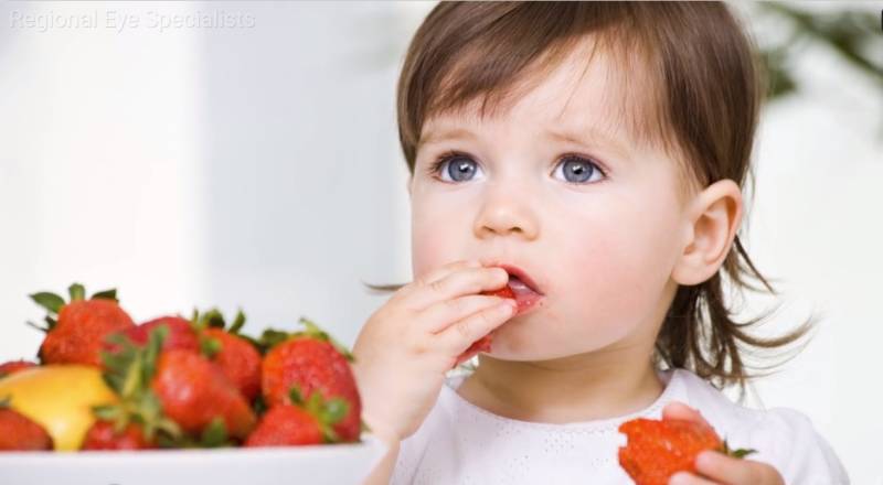Toddler eating fruit